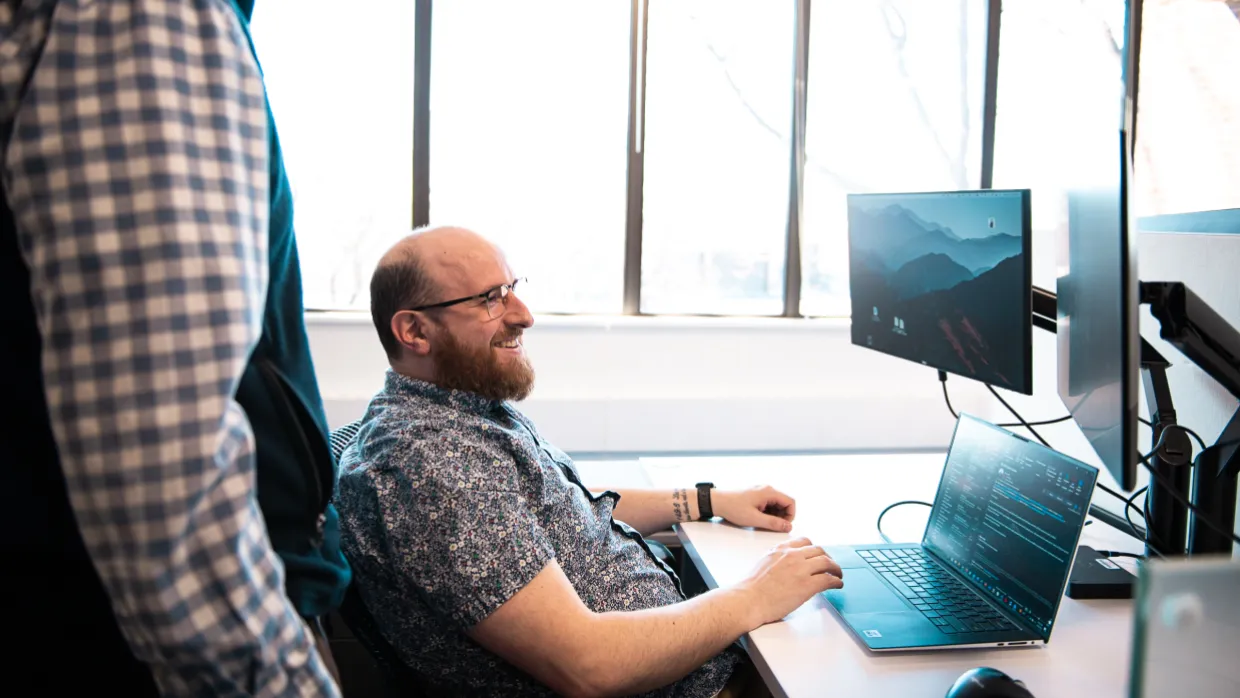 two men collaborating over technology